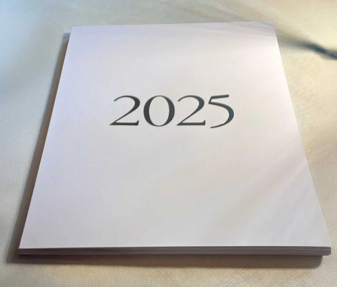 Printed photography magazines laid out on a table